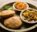 Hot Kachori Sabzi served on a leaf plate in a narrow lane of Banaras.